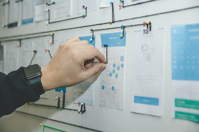 manually connecting the dots between process cards on whiteboard